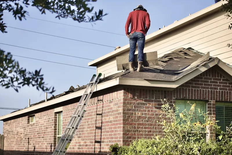 Professional roofer working on a residential roof in Bethesda